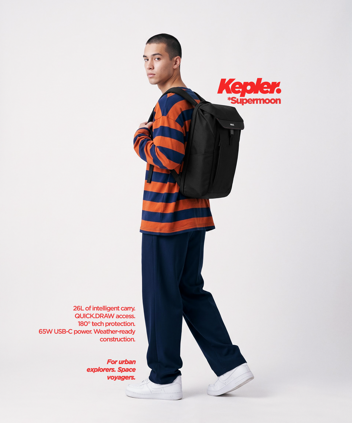 A man carries a black Mule backpack with a top flap and front zipper pocket, photographed against a light gray studio background.