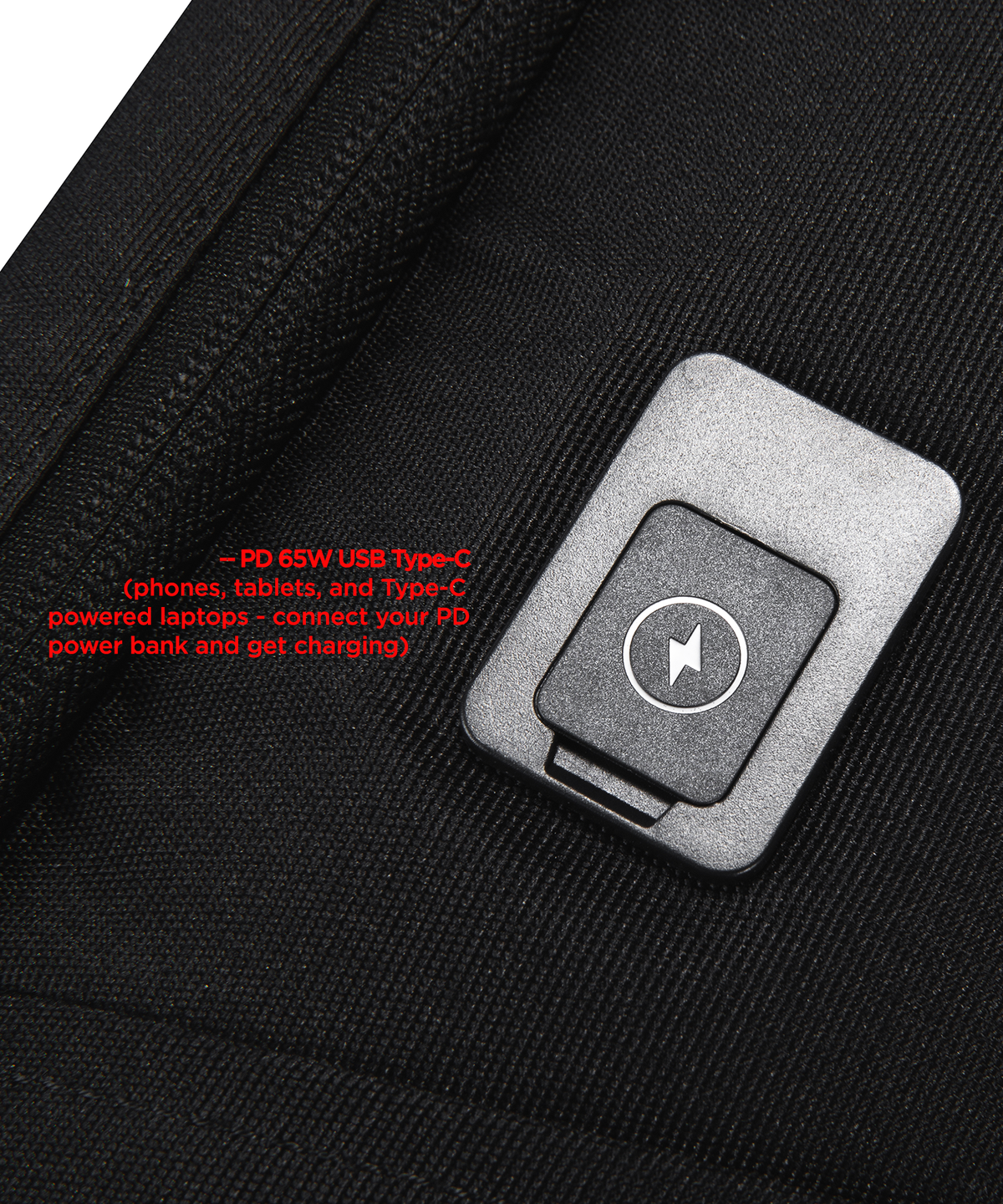 Close-up of a black fabric bag with a USB C Port attached with a white lightning bolt symbol and red text explaining USB-C charging compatibility.